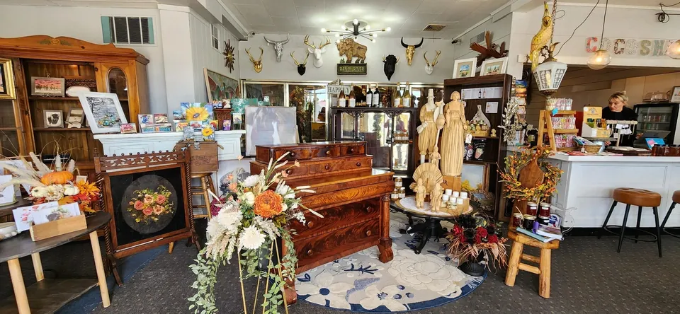 A variety of antiques and treasures, including cabinets, statues and home decor on display.