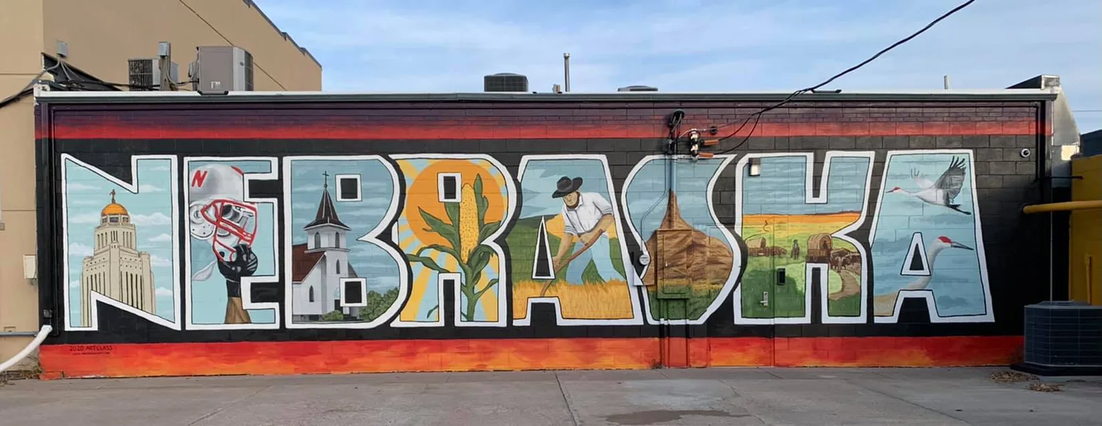 Colorful Nebraska mural painted on a brick wall